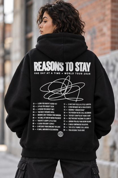 Deluxe oversized black hoodie, back view with white Reasons to Stay World Tour 2026 print and 20 reasons list