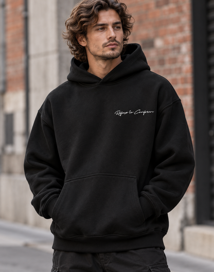 Original ultra-heavy black hoodie, front view with small white Refuse to Conform left chest logo