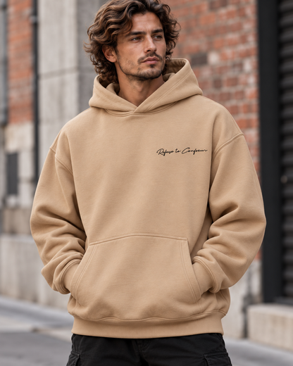 Front view of the sand Deluxe Ultra-Heavy hoodie with black chest logo